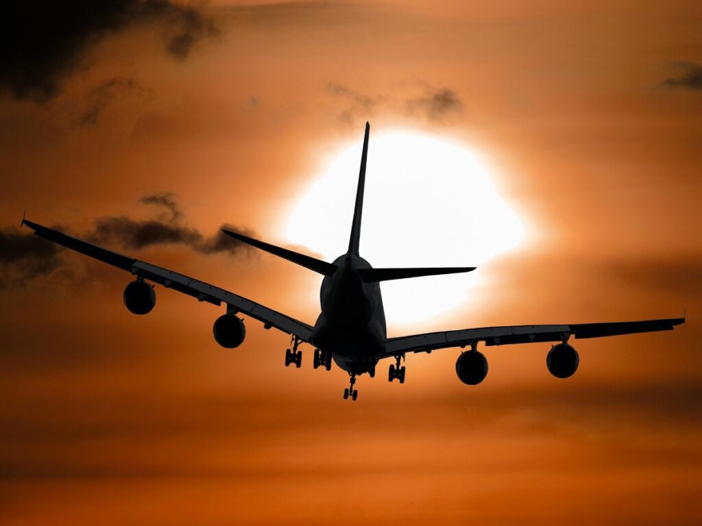 Plane flying into the sunset