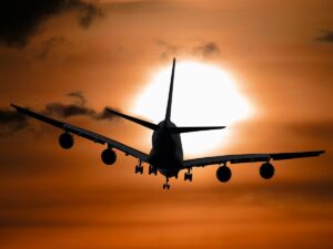 Plane flying into the sunset