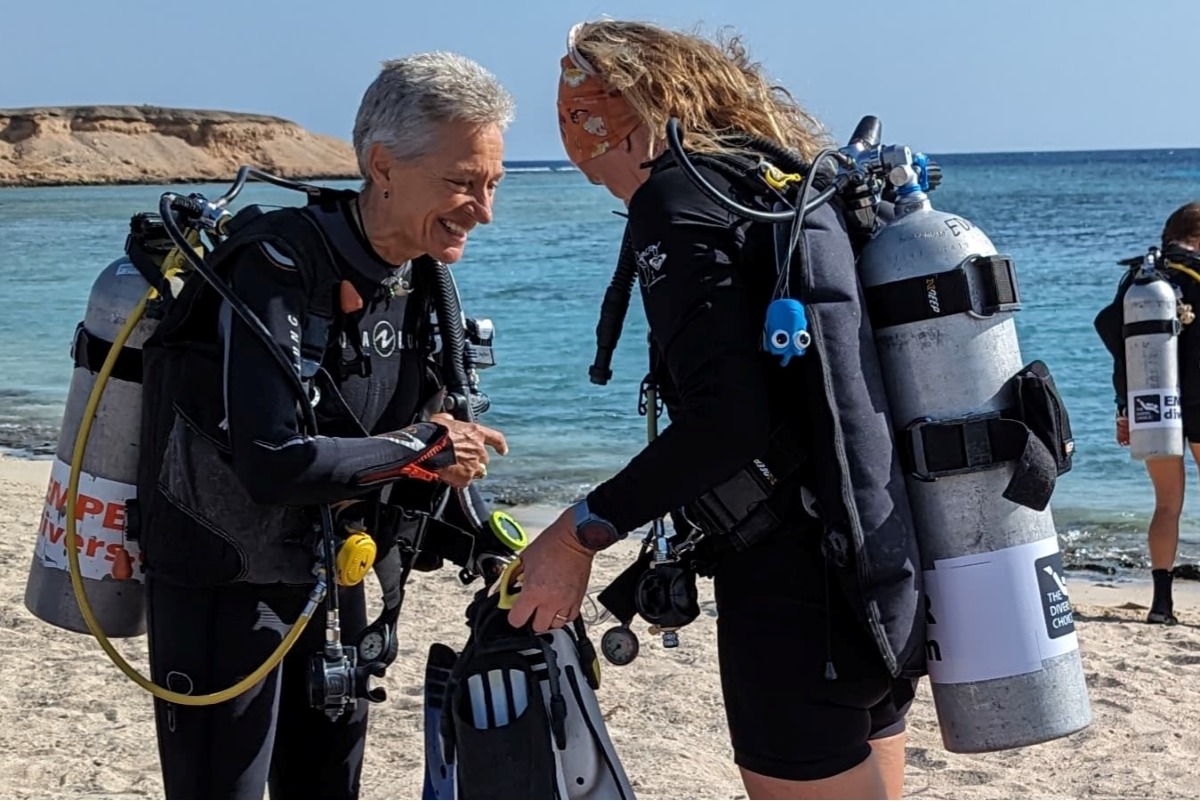 Sonia Goggel and Tracy Atkinson share a laugh while preparing to dive