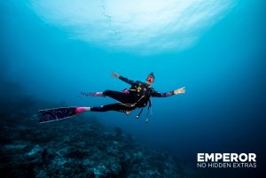 A female diver happily explores the Indian Ocean in the Maldives